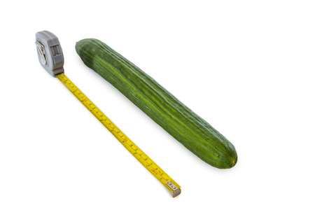 a cucumber and a measuring tape isolated on white backgroundの写真素材