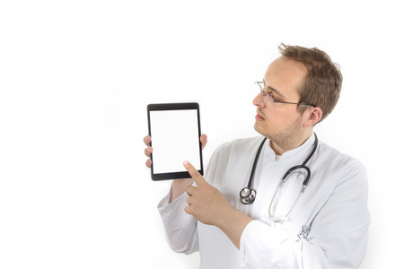 Young Doctor with laboratory coat and stethoscope presenting a tablet computer with isolated screen isolated on white backgroundの写真素材