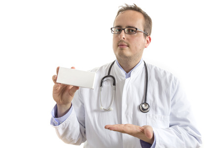 Young Doctor with laboratory coat and stethoscope presenting a clean white box isolated on white backgroundの写真素材