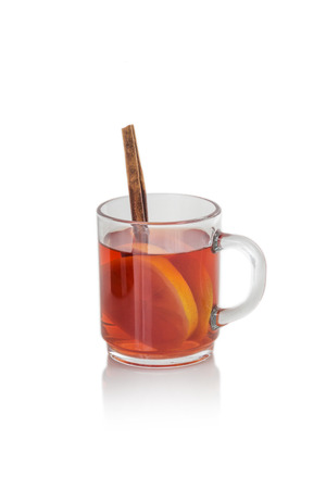 Glass of hot spiced wine with cinnamon oranges and star anise isolated on white backgroundの写真素材