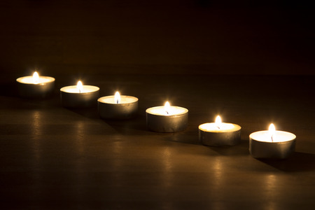 Row of wooden tera candles on wooden backgroundの写真素材