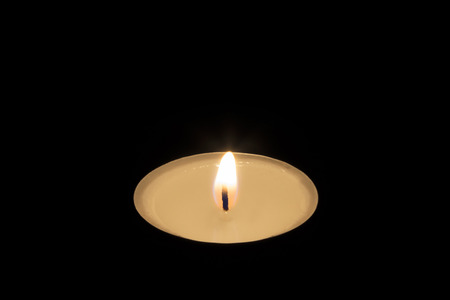 A Single Tea Candle isolated on black backgroundの写真素材