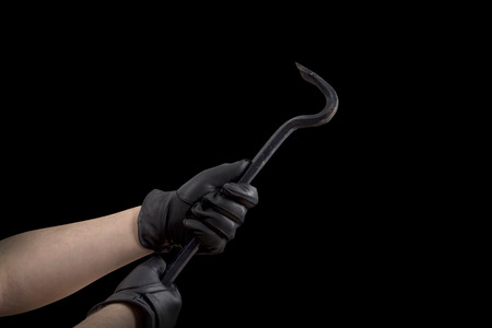 A Hand in black leather gloves holding a cow barの写真素材