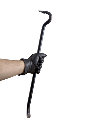 A Hand in black leather gloves holding a cow barの写真素材