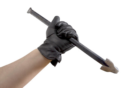 A Hand in black leather gloves holding a cow barの写真素材