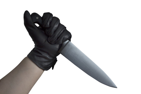 An Arm with black leather gloves holding a large knifeの写真素材