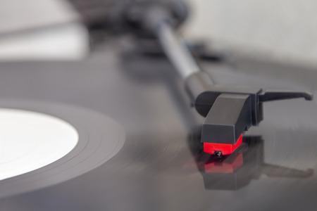 Detail view of record player with spinning discの写真素材
