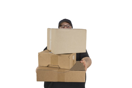 delivery driver in blue uniform looking over a stack of a parcels isolated on white background
