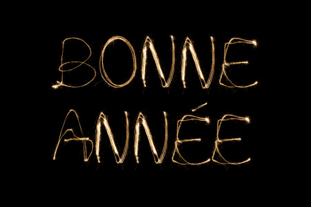 Bonne Annee (French Happy new Year) written with a sparkler isolated on black backgroundの写真素材