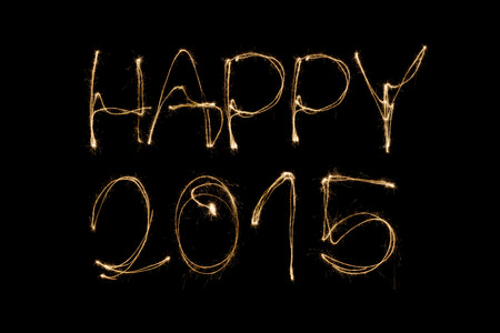 Happy 2015 written with a sparkler isolated on black backgroundの写真素材