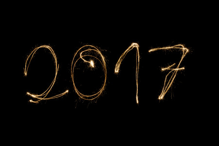 2017 written with a sparkler isolated on black backgroundの写真素材