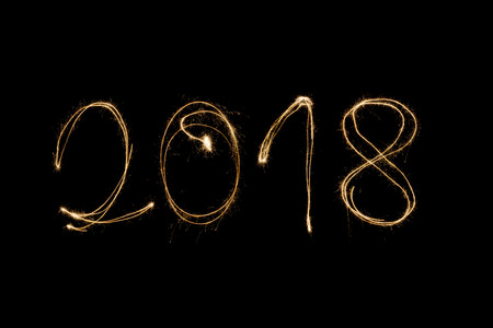 2018 written with a sparkler isolated on black backgroundの写真素材