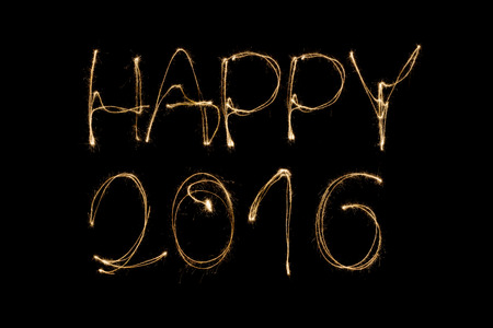 Happy 2016 written with a sparkler isolated on black backgroundの写真素材