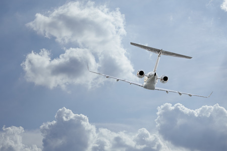 Following a private jet flying through the cloudsの写真素材