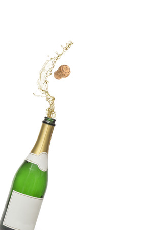 The Cork popping out of a bottle of champagne isolated on white backgroundの写真素材
