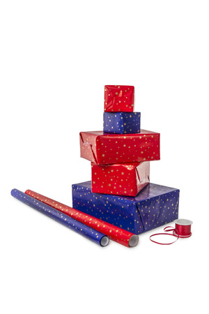 Stack of five presents in different sizes with blue and red wrapping paper and ribbon isolated on white backgroundの写真素材