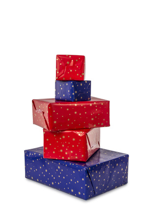 Stack of five presents in different sizes wrapped in blue and red paper isolated on white backgroundの写真素材