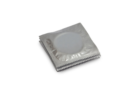 Stack of thre Condoms in silver Packing isolated on white backgroundの写真素材