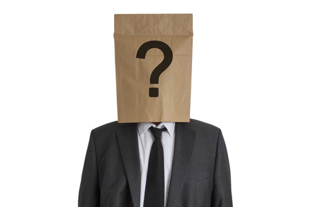 A Man in suit with a paper bag with question mark on his head isolated on white backgroundの写真素材