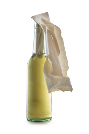 Glass bottle filled with gasoline, a so called Molotov Cocktail, isolated on white backgroundの写真素材