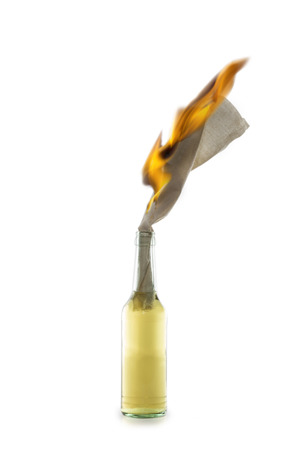 Glass bottle filled with gasoline, a so called Molotov Cocktail, with burning fuse isolated on white backgroundの写真素材