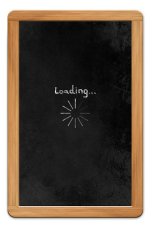 Blackboard with wooden frame and chalk drawn tablet computer loading symbol, isolated on white backroundの写真素材