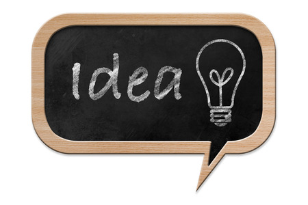 Idea and a light bulb drawn on a Blackboard in speech bubble shape with wooden frame, isolated on white backroundの写真素材