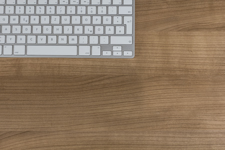 a Modern keyboard on wooden Desktopの写真素材