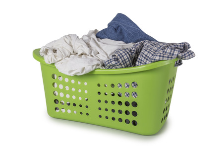 Green Laundry Basket filled with clothes isolated on white backgroundの写真素材