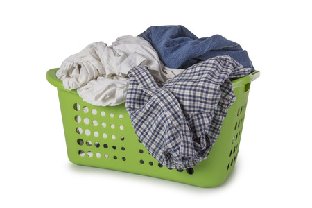 Green Laundry Basket filled with clothes isolated on white backgroundの写真素材