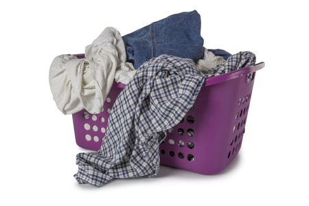 Violet Laundry Basket filled with clothes isolated on white backgroundの写真素材