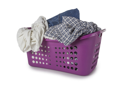 Violet Laundry Basket filled with clothes isolated on white backgroundの写真素材