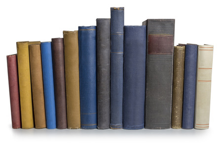 A row of old books isolated on white backgroundの写真素材
