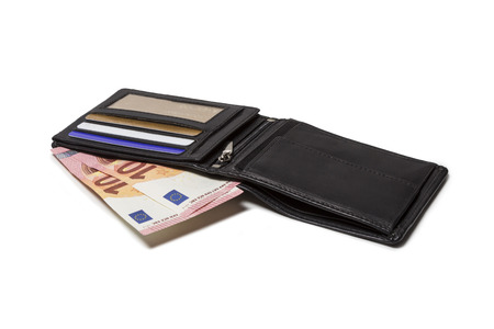 Black leather purse with credit cards and new 10 euro bills isolated on white backgroundの写真素材