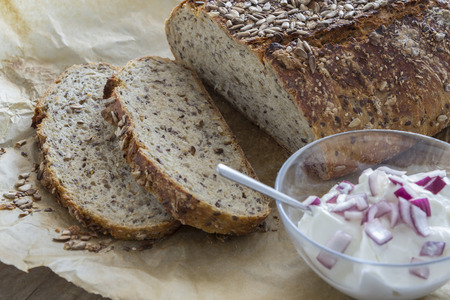 Homemade brown bread on a rustic wooden tableの写真素材