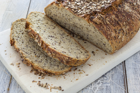 Homemade brown bread on a rustic wooden tableの写真素材