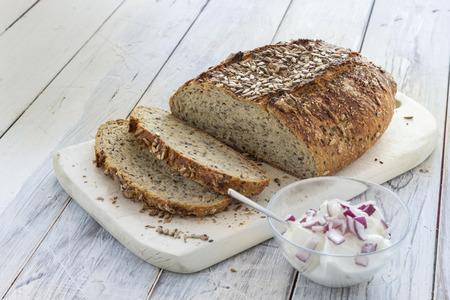 Homemade brown bread on a rustic wooden tableの写真素材