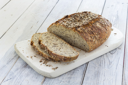 Homemade brown bread on a rustic wooden tableの写真素材