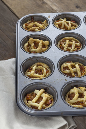 Mini apple pies in a muffin trayの写真素材