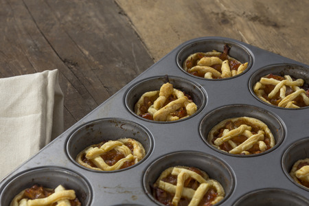 Mini apple pies in a muffin trayの写真素材
