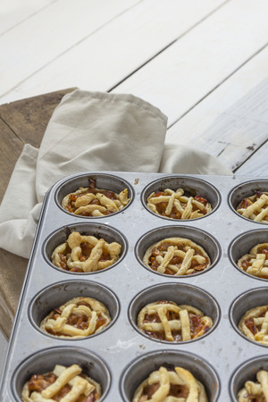 Mini apple pies in a muffin trayの写真素材
