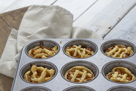 Mini apple pies in a muffin trayの写真素材