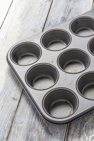 Muffin baking tray on a rustic wooden tableの写真素材
