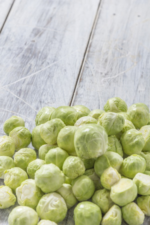 Brussels sprouts on a white wooden tableの写真素材