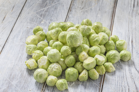 Brussels sprouts on a white wooden tableの写真素材