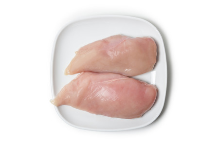 Two pieces of chicken breast fillet on aplate isolated on white backgroundの写真素材