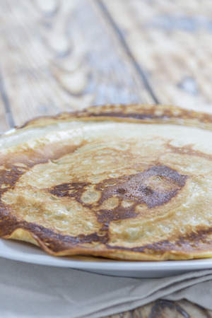 Homemade Pancakes on a plate on a rustic wooden tableの写真素材