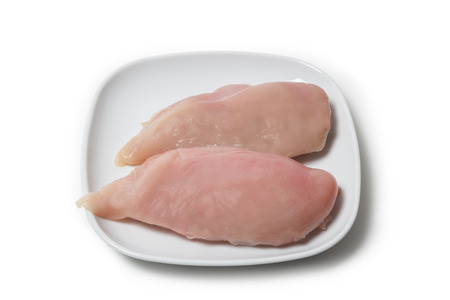 Two pieces of chicken breast fillet on aplate isolated on white backgroundの写真素材