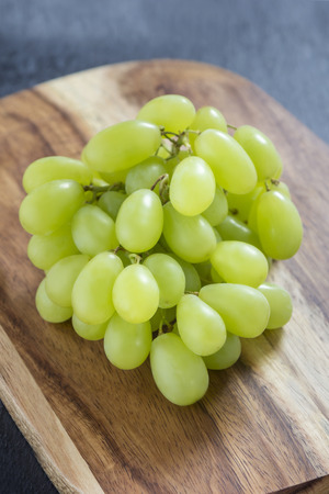 fresh green grapes on wooden boardの写真素材