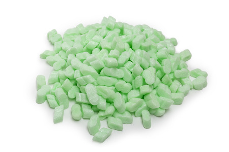 heap of green foam packing fillers isolated on white backgroundの写真素材